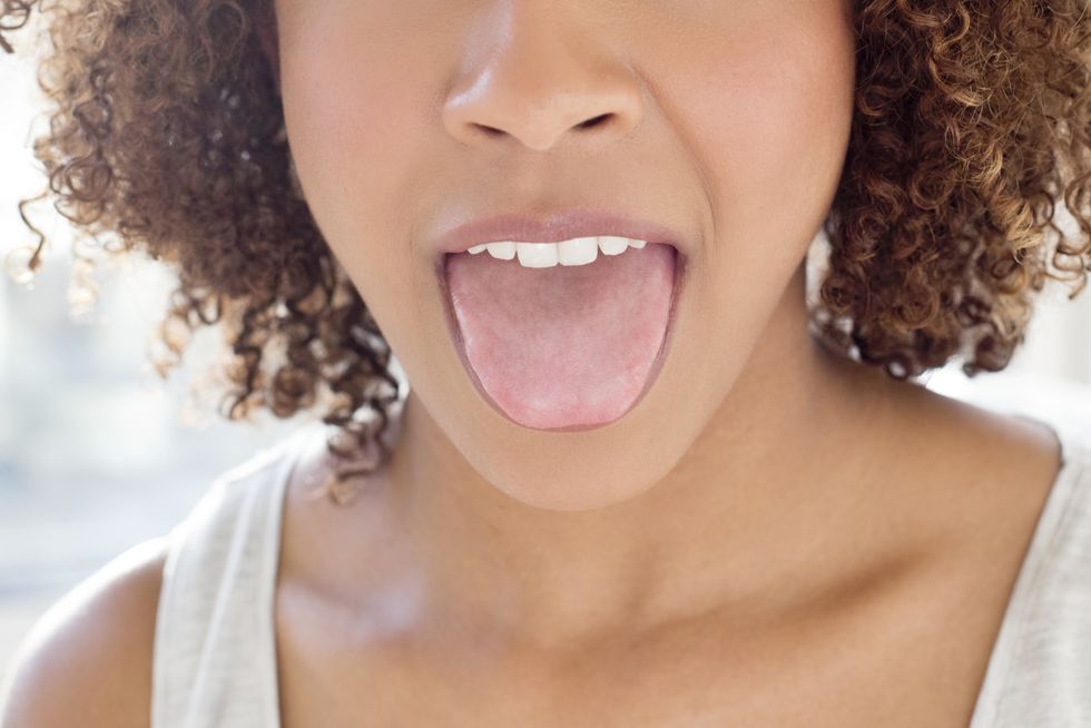 portrait of mid adult woman sticking out tongue