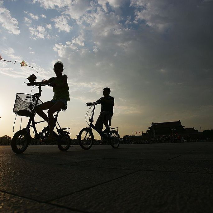 beijing   july 10 children ride their bicycles through  the tiananmen square, which has been the site of numerous political and diplomatic events, on july 10, 2007 in beijing, china beijing will host games of the xxix olympiad from august 8 to 24, 2008  photo by feng ligetty images