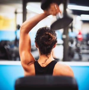 Rear View Of Woman With Arms Raised