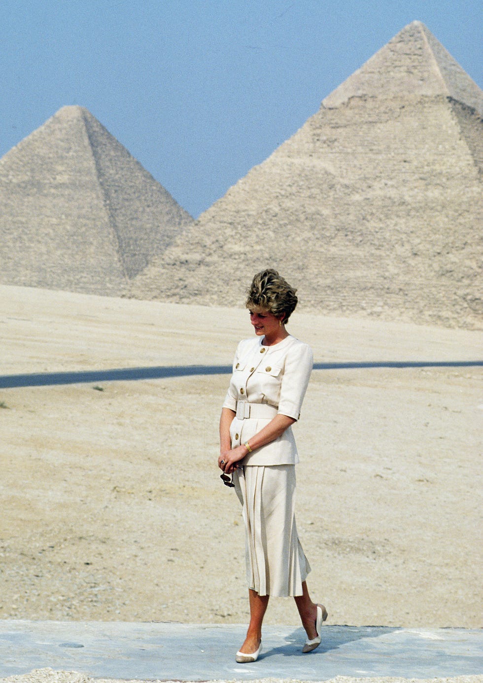may 12 diana, princess of wales, wearing a beige safari suit jacket and skirt designed by catherine walker, visits the pyramids in giza during an official tour of egypt on may 12, 1992 in cairo, egypt