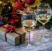 Close-Up Of Wineglasses With Christmas Decoration On Table