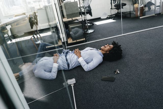 Young woman lying on the floor in office