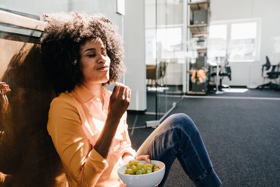 young woman eating grapes