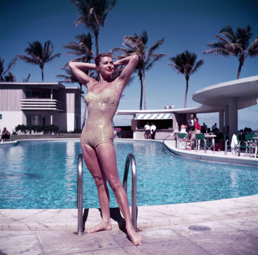 american swimmer and actress esther williams posing by the pool in a sparkly gold swimsuit, florida, 1955 photo by slim aaronshulton archivegetty images  local caption  esther williams