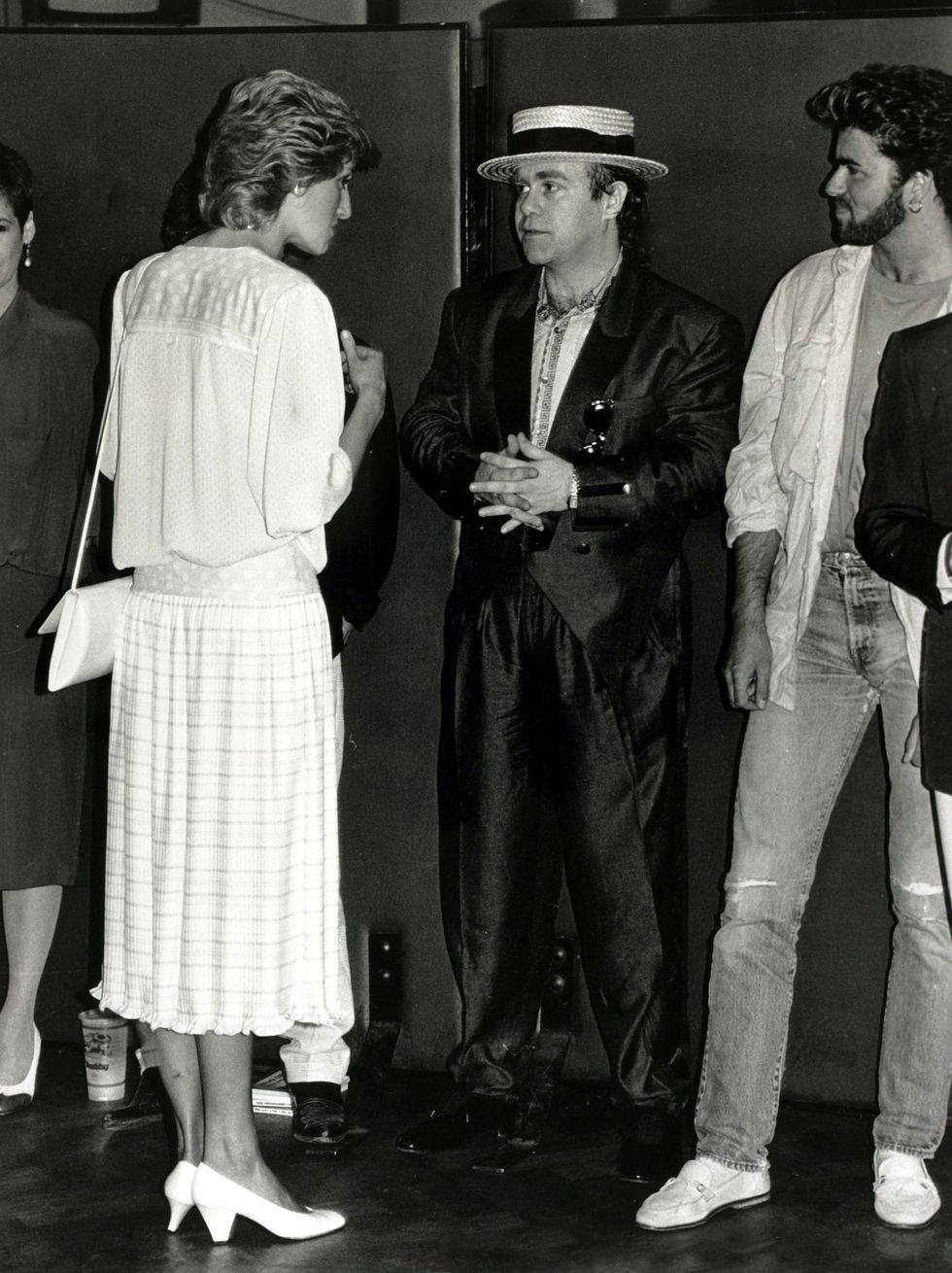 Princess Diana chatting with Elton John and George Michael at the Feed the World Live Aid concert in July 1985