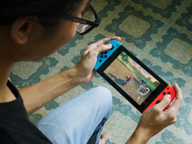 bangkok, thailand   june 25, 2017  a man playing mario kart 8 deluxe on nintendo switch