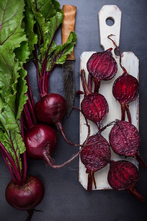 roasted beetroots and fresh vegetables on rural table viewed from above
