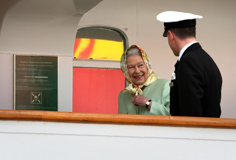 britains queen elizabeth ii boards the hebridean princess in stornoway with captain michael hepburn right, as the royal family begin a holiday around the western isles   photo by andrew milliganpa images via getty images