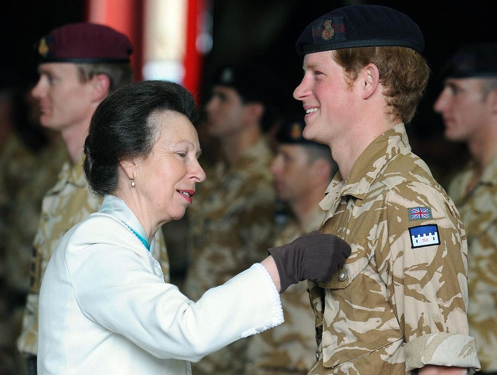 Britain's Princess Anne (L) presents a c