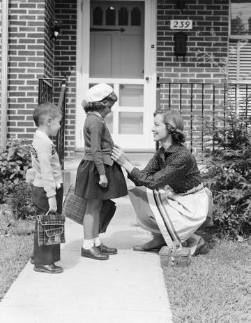 united states door, buttoning sweater of daughter going off to school with her brother