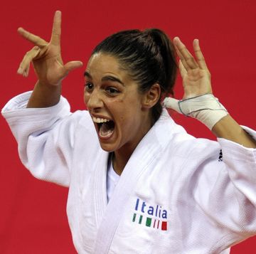 italys giulia quintavalle celebrates on the podium before receiving her gold medal for the womens  57kg of the 2008 beijing olympic games on august 11, 2008 in beijing italy giulia quintavalle won the judo final against netherlands deborah gravenstijn     afp photo  olivier morin photo credit should read olivier morinafp via getty images