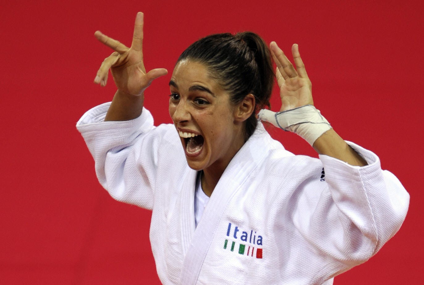 italys giulia quintavalle celebrates on the podium before receiving her gold medal for the womens  57kg of the 2008 beijing olympic games on august 11, 2008 in beijing italy giulia quintavalle won the judo final against netherlands deborah gravenstijn     afp photo  olivier morin photo credit should read olivier morinafp via getty images
