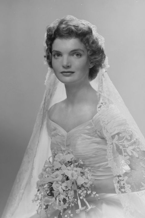 bridal portrait of jacqueline lee bouvier 1929   1994 shows her in an anne lowe designed wedding dress, a bouquet of flowers in her hands, new york, new york, 1953 photo by bachrachgetty images