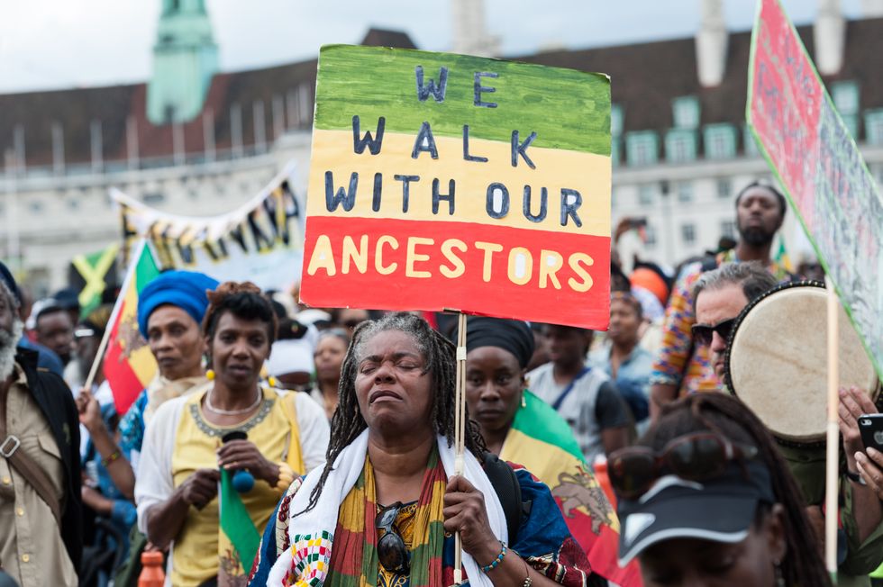 london, united kingdom   august 01 hundreds of people of african descent took part in the afrikan emancipation day reparations march on august 01, 2017 in london, england 

participants marched from brixton to parliament square calling for slavery and colonization reparations, demanded social justice and demonstrated an african culture and identity

photograph by wiktor szymanowicz  barcroft images

london t44 207 033 1031 ehellobarcroftmediacom  
new york t1 212 796 2458 ehellobarcroftusacom  
new delhi t91 11 4053 2429 ehellobarcroftindiacom wwwbarcroftimagescom photo credit should read wiktor szymanowicz  barcroft im  barcroft media via getty images