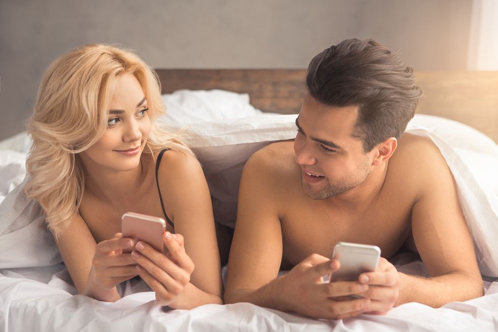 Young couple intimate relationship on bed technology
