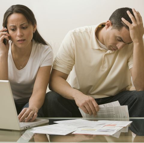 Hispanic couple having difficulty paying bills online