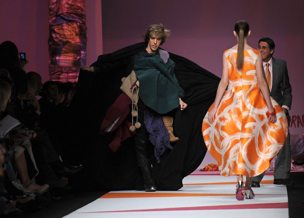 british actor sacha baron cohen l gets on the catwalk as an official r tries to stop him during the fashion show of spanish fashion designer agatha ruiz de la prada as part of the womens springsummer 2009 ready to wear collections of the fashion week in milan on september 26, 2008    afp photo  filippo monteforte photo credit should read filippo monteforteafp via getty images