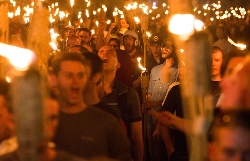 neo nazis, alt right, and white supremacists take part a the night before the unite the right rally in charlottesville, va, white supremacists march with tiki torchs through the university of virginia campus  photo by zach d robertsnurphoto via getty images