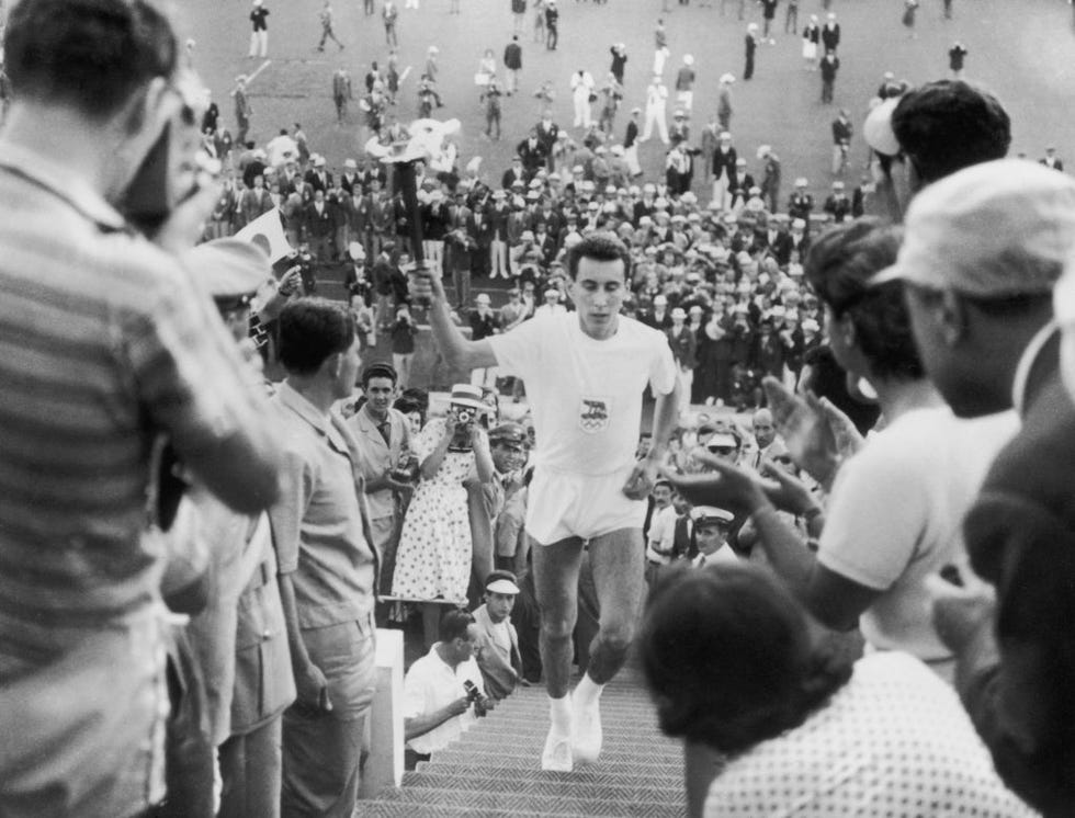 italian athlete giancarlo peris brings the olympic flame to the olympic stadium in rome for the opening ceremony of the games, 26th august 1960 photo by keystonehulton archivegetty images