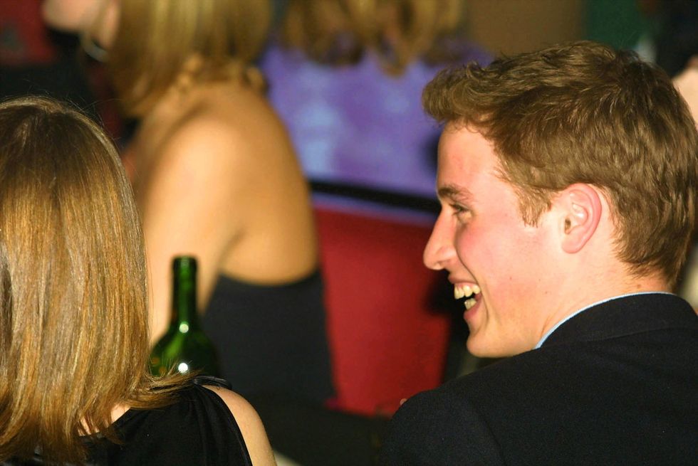 a man laughing and talking to a woman