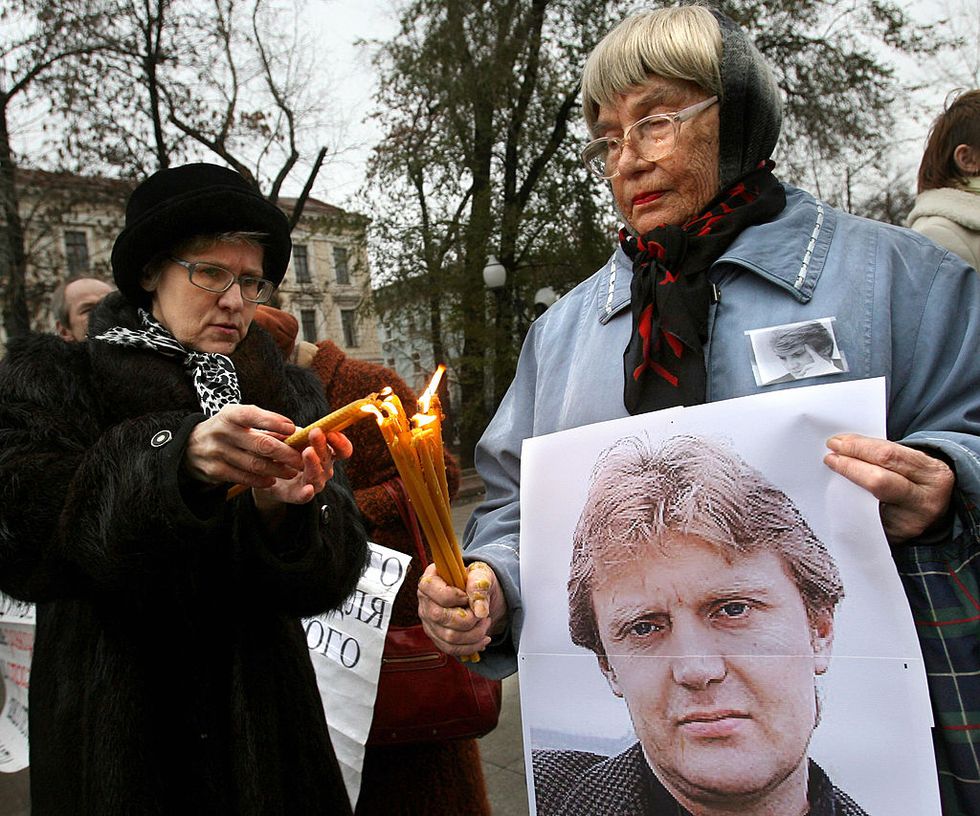 women holding a poster of deceased former russian spy alexander litvinenko light candles in his honor in moscow on november 22, 2008 the man accused of murdering litvinenko in london said in a british newspaper that he was prepared to come to britain to be questioned about the case andrei lugovoi, a russian lawmaker and an ex kgb agent, told the times that he was considering sending his friend, dmitry kovtun, who was one of the last people to meet litvinenko before he fell ill, to meet detectives afp photo alexey sazonov photo credit should read alexey sazonovafp via getty images