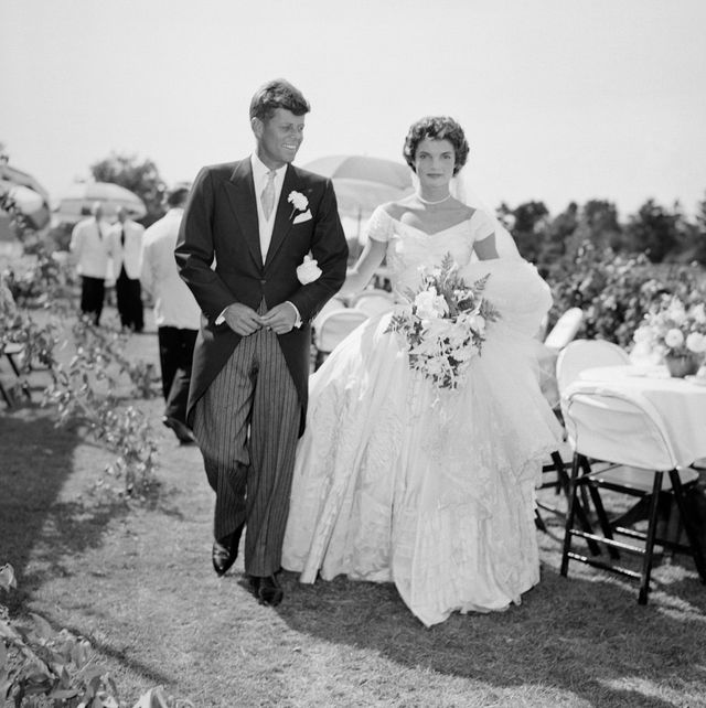 a scene from the kennedy bouvier wedding groom john walks alongside his bride jacqueline at an outdoor reception, 1953 newport, rhode island photo by bachrachgetty images
