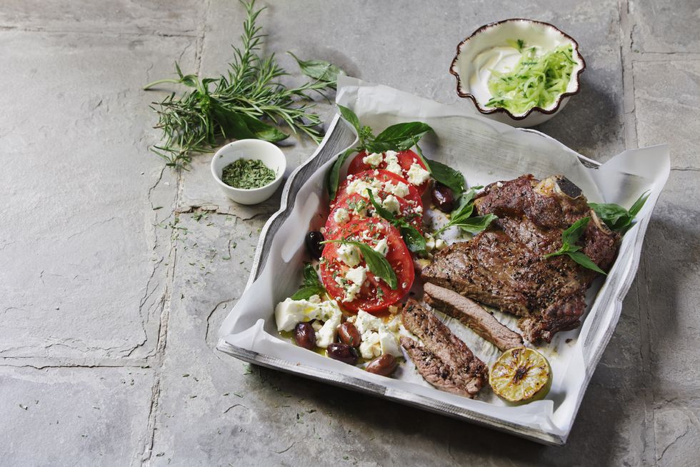 Char-grilled beef steak with herbs, tomato and feta salad