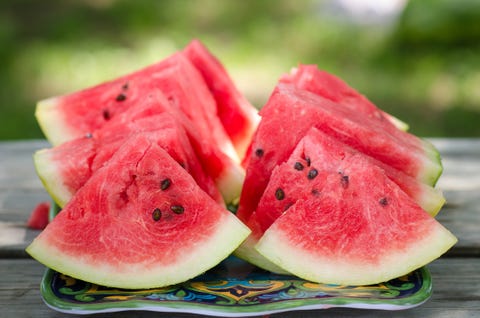 dallas, tx   june 12, 2015 freshly cut watermelon slices are displayed on a picnic table outside the perfect food for a summertime picnic they are ready to be eaten