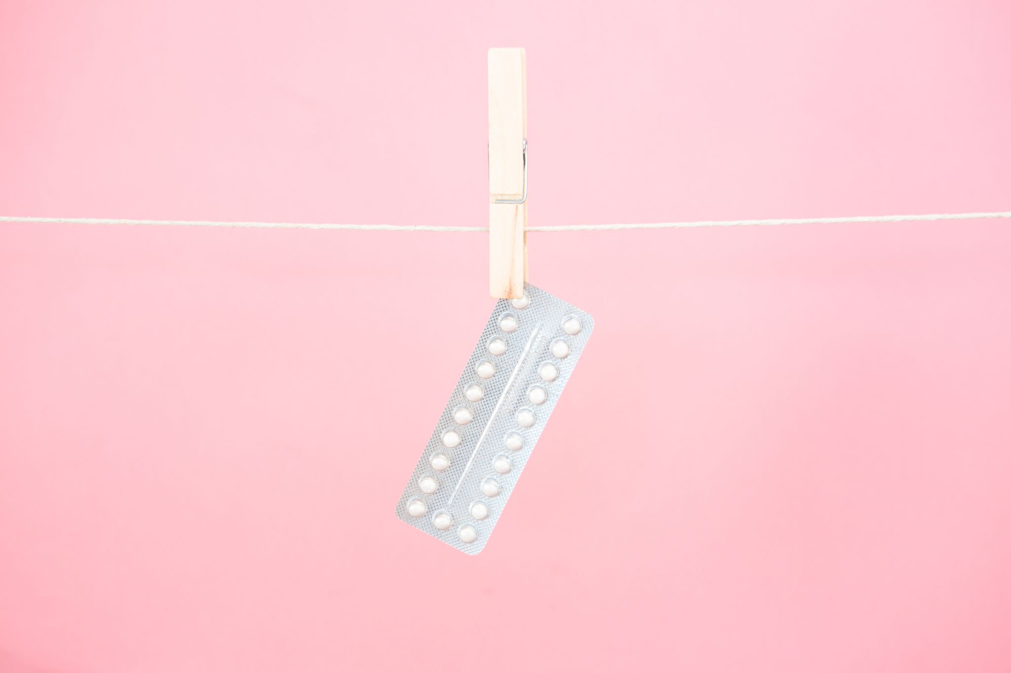 Contraceptive pill blister pack hanging from line