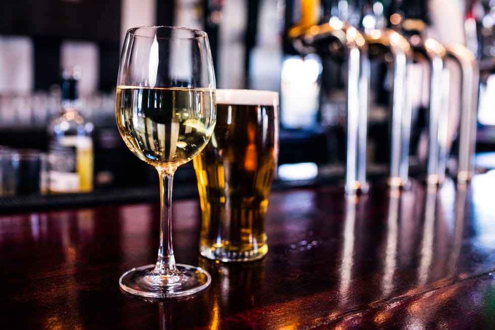 Close up of a glass of wine and a beer