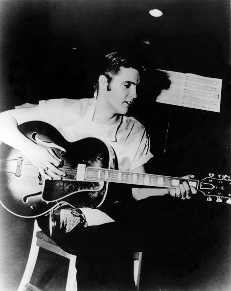 elvis life in photos united states january 01 usa photo of elvis presley, playing guitar sitting on stool with sheet music behind, c1956 photo by charlie gillettredferns