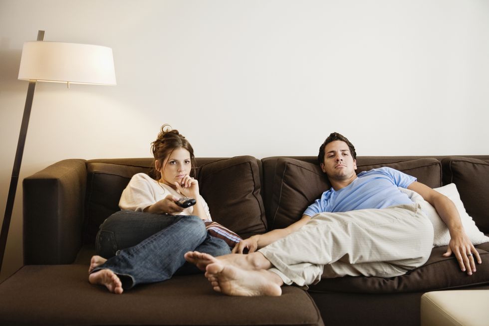 young couple on sofa watching television