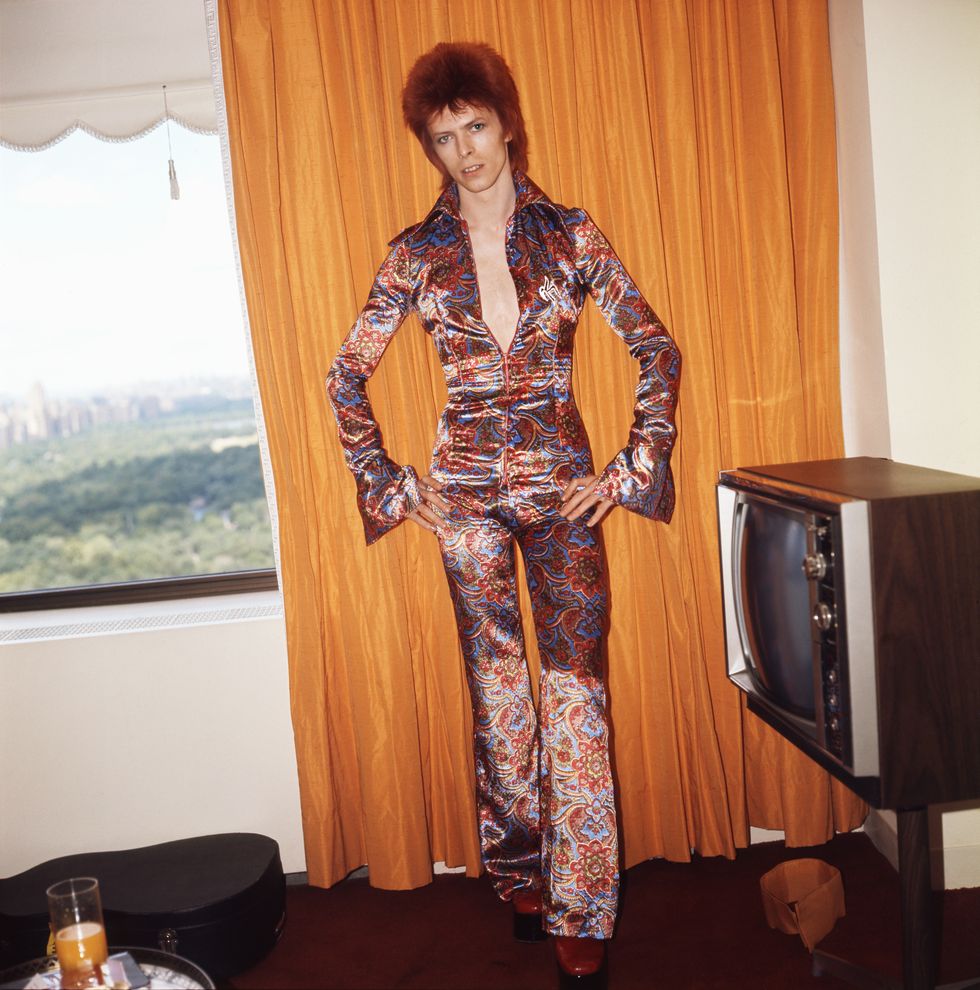 David Bowie poses for a portrait dressed as Ziggy Stardust in a hotel room in New York City, 1973