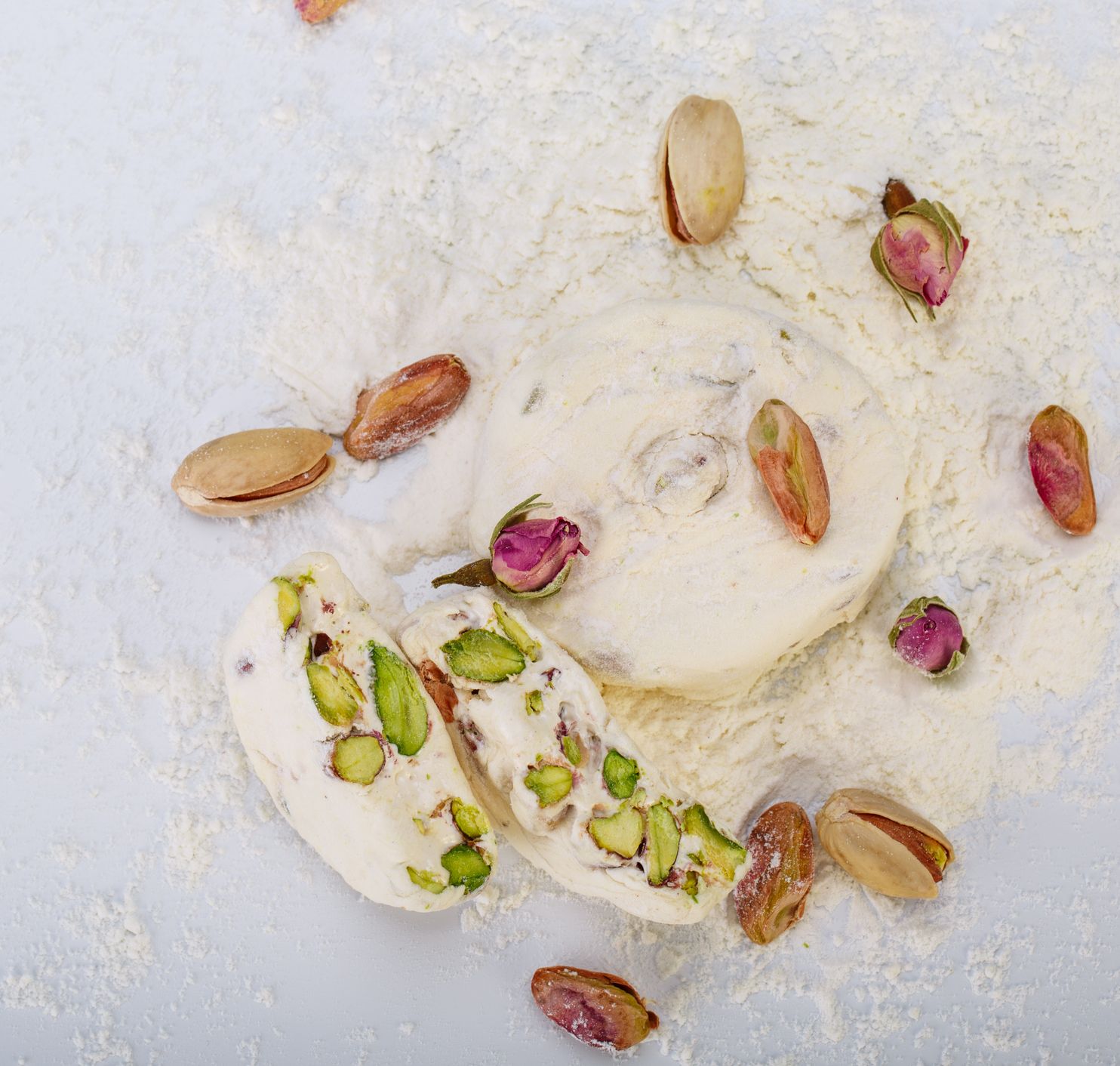 Top view Traditional Iranian and Persian pieces of white nougat dessert sweet candies (Gaz) with Pistachio nuts from Isfahan City empty space for typing text