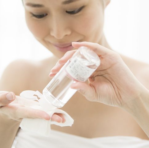 a woman doing skin care with cosmetic lotion