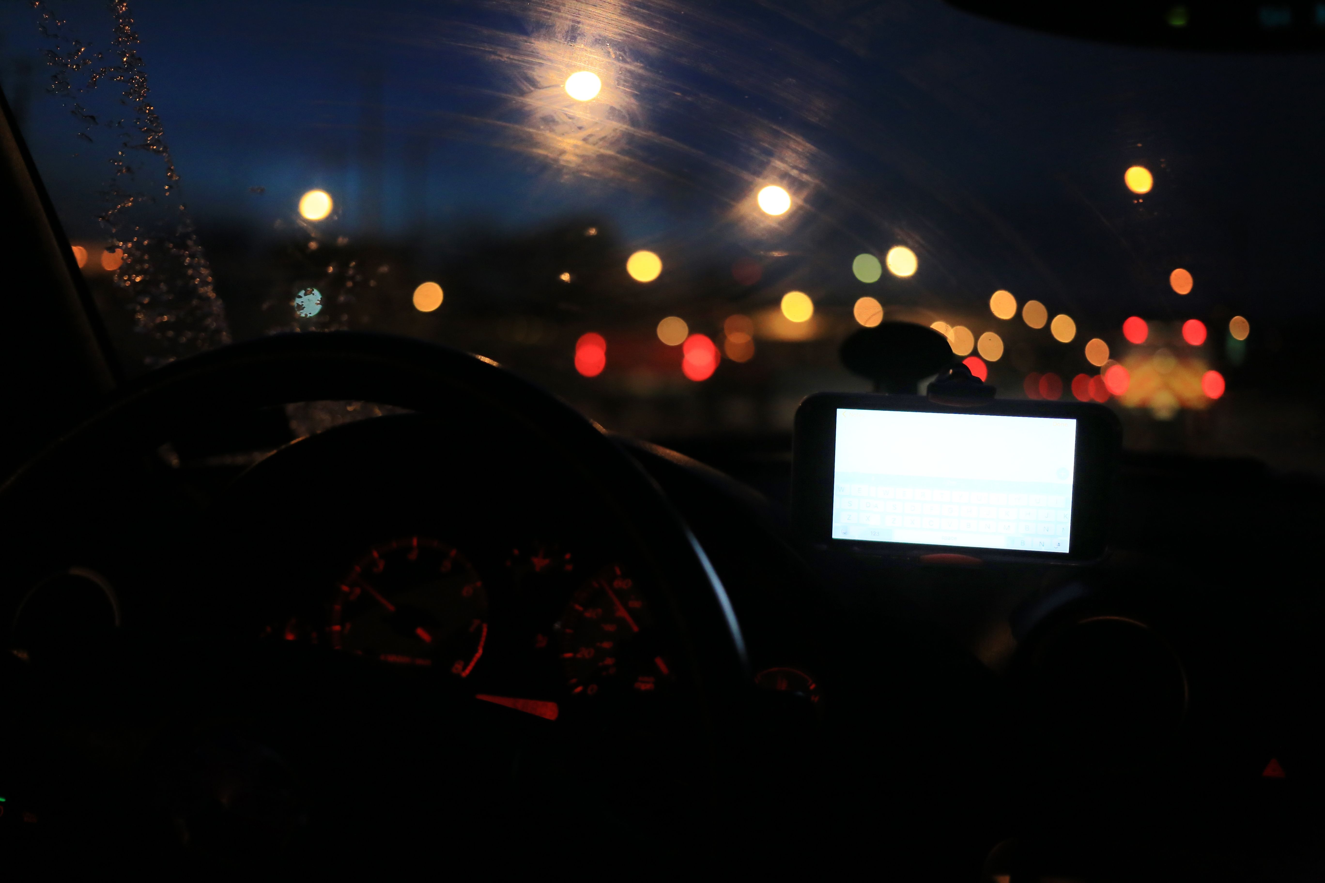 Late night drive through city with reflections of headlights