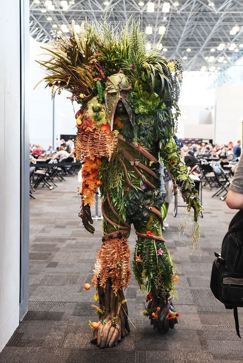 Ghillie suit, Military camouflage, Tree, Costume, Plant, Carnival, Event, Tradition, Performance art, Fictional character, 