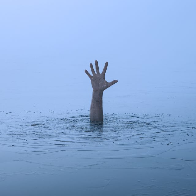 danger, problems concept close up of human hand drowning in the lake