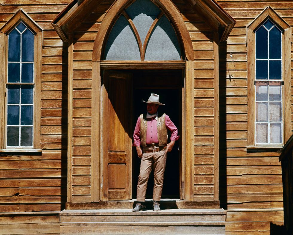 american actor john wayne 1907 1979 as col cord mcnally stands in a doorway on the set of rio lobo directed by howard hawks, 1970 photo by silver screen collectiongetty images