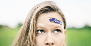Young Woman With Band-Aid on Forehead