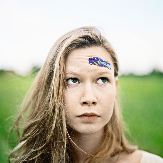 Young Woman With Band-Aid on Forehead