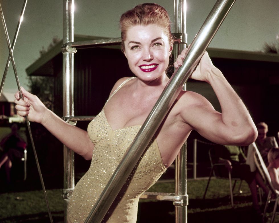 portrait of american swimmer and actress esther williams 1921   2013, in a gold, sequin swimsuit, as she poses beside the ladder to a diving board, mid 1950s photo by silver screen collectiongetty images
