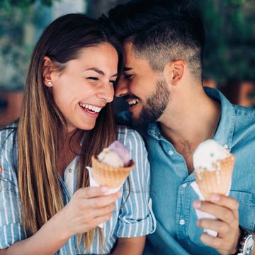 Happy couple having date and eating ice cream