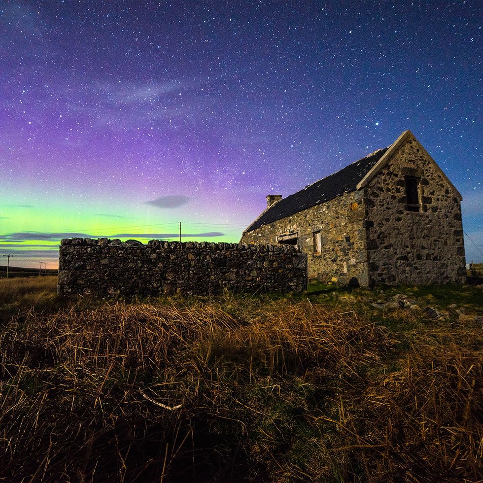 the spectacular aurora borealis dances across the night sky in the outer hebrides an abandoned building provides an interesting scene and a people free landscape image taken in north uist in the outer hebrides, off the coast of north west scotland