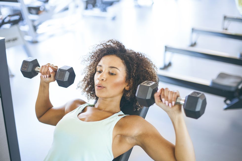 can you continue to burn calories after working out a young woman weightraining at the gym