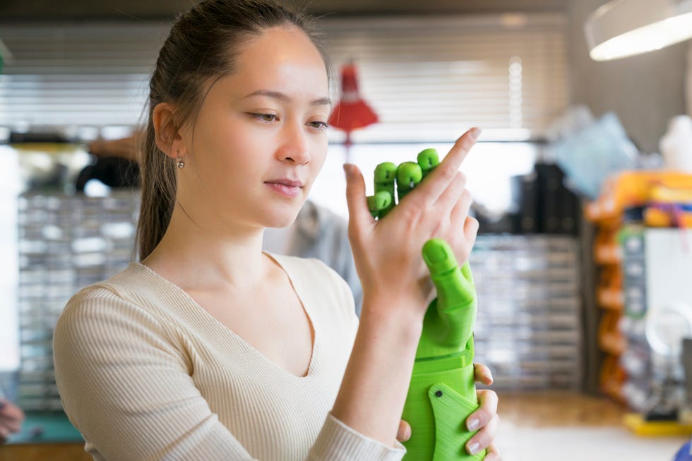 Engineer examining robotics in workshop