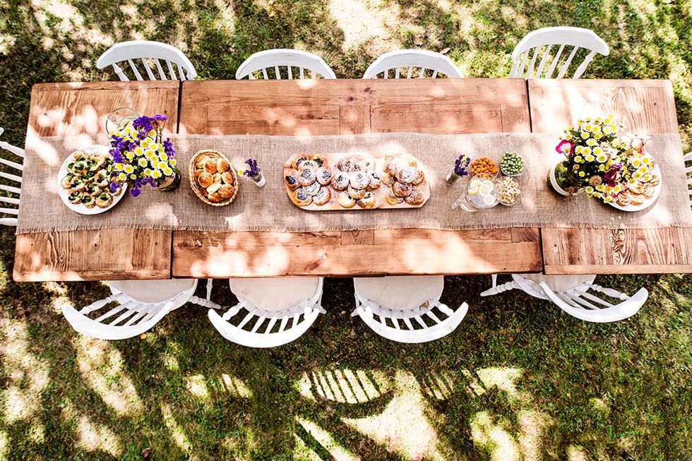 table set for a garden party or celebration outside in the backyard aerial view