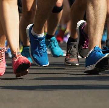 marathon runners running on city road,detail on legs