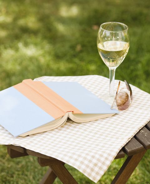Wine glass and book on outdoor table