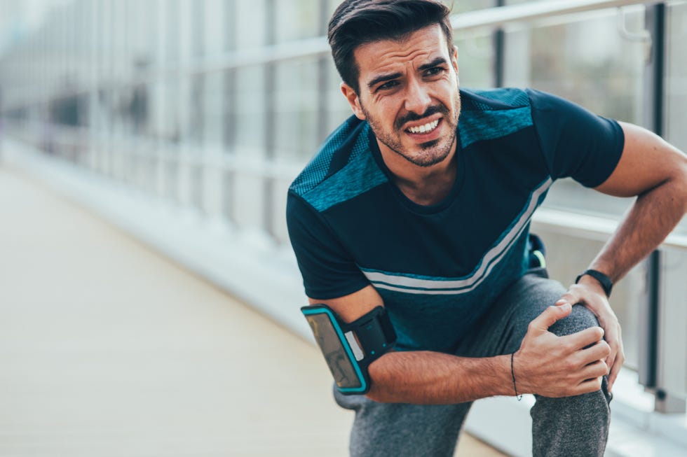 sportsman hurting his knee during workout